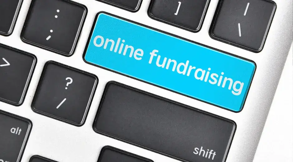 Keyboard with a highlighted blue key reading online fundraising.
